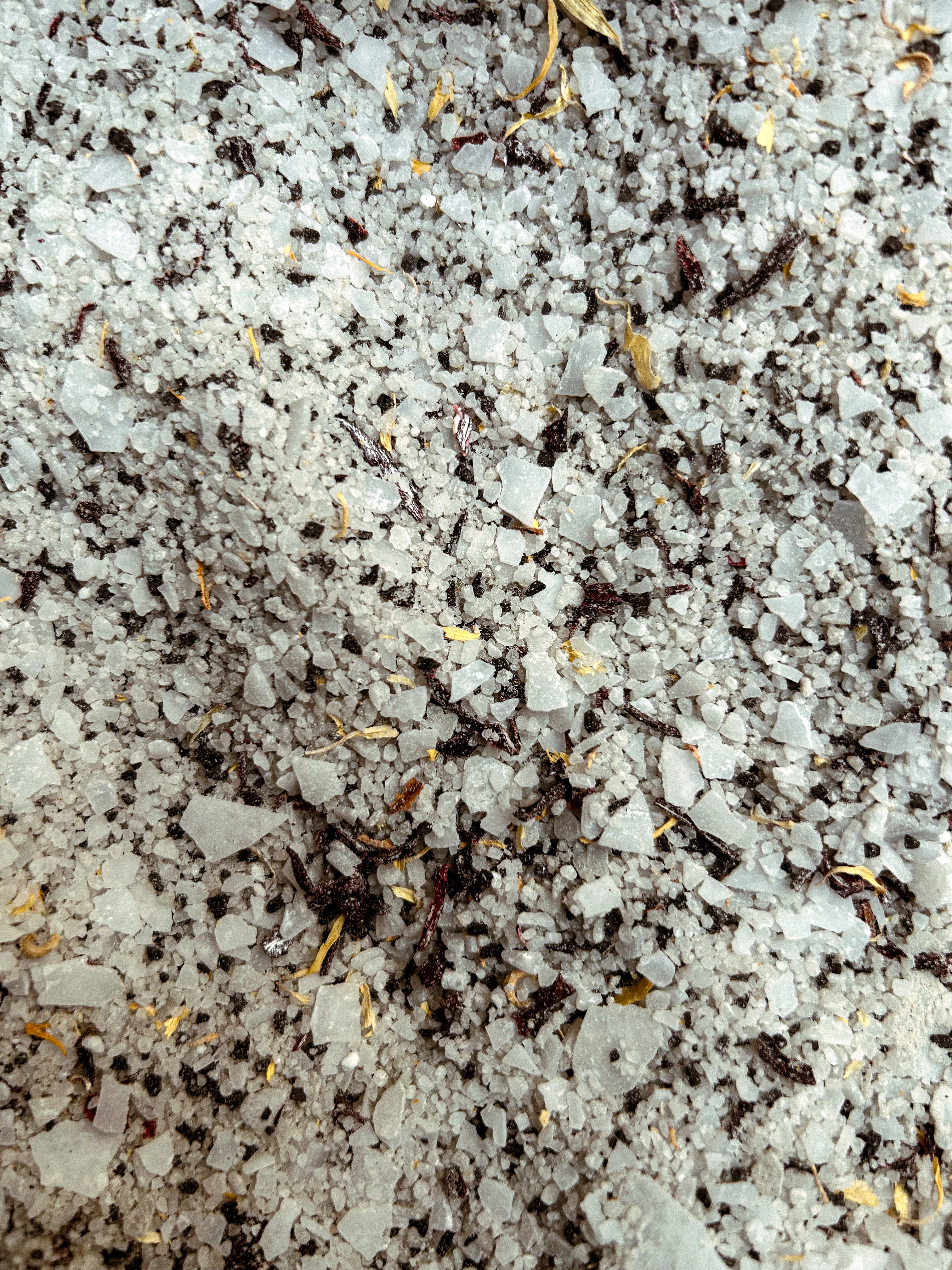 Close-up shot of Honey Noon bath soak with dried hibiscus and calendula. 