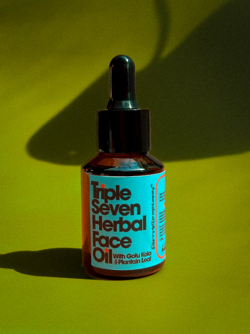 Bottle of Triple Seven Herbal Face Oil on a green retro color grading background