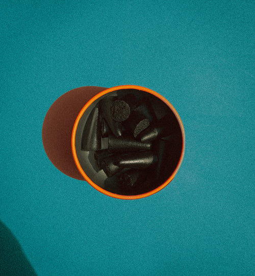 overhead photo shot with 'Sunday' scented hand dipped charcoal incense cones branding on a blue background.